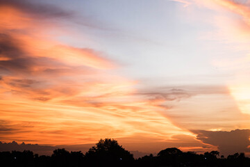 Evening sky sunset.  big puffy cumulus and long stratus clouds. sky background with clouds