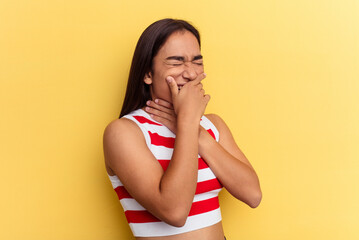 Young mixed race woman isolated on yellow background suffers pain in throat due a virus or infection.