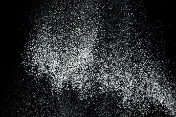 White powder explosion. White powder splash isolated on black background. Flour sifting on a dark background. Explosive powder white