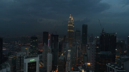 Fototapeta na wymiar AERIAL. Cinematic view. Hight view to Kuala Lumpur city, Malaysia. Cityscape business skyscrapers night downtown.