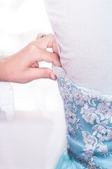 Woman's hand adjusting a bridal corset