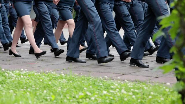 Men and women in military uniforms march across the parade ground on a cloudy summer day. Federal Service for the Execution of Punishments in Russia.