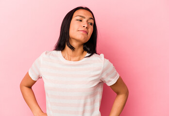 Fototapeta premium Young Venezuelan woman isolated on pink background dreaming of achieving goals and purposes