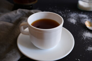 Cup of black coffee on black background