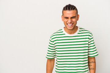 Fototapeta premium Young venezuelan man isolated on white background shouting very angry, rage concept, frustrated.
