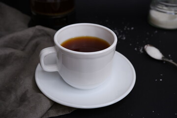 Cup of black coffee on black background