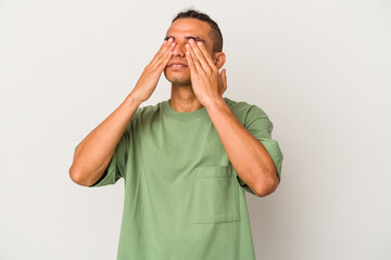 Young venezuelan man isolated on white background afraid covering eyes with hands.