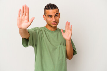 Young venezuelan man isolated on white background being shocked due to an imminent danger
