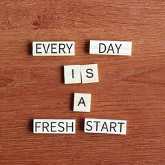 Obraz premium EVERY DAY IS A FRESH START quote written on wooden cubes.