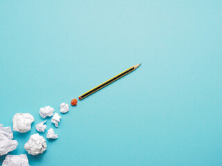 Launching pencil rocket with jet stream of paper balls, creativity concept or new ideas metaphor