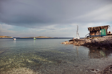 Fototapeta na wymiar Sea ocean coast with small boats and calm water.