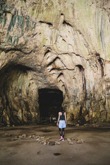 Traveler girl exploration a devetashka cave near Lovech