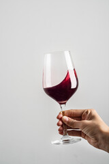 hand with wine glass on white background.