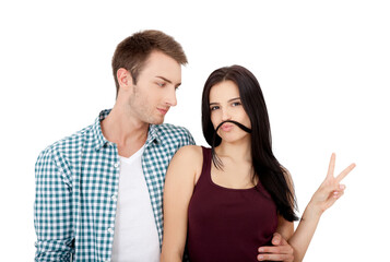 Beautiful young couple bonding to each other and smiling while making a fake mustaches from her hair