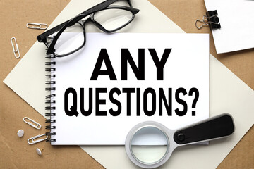Any questions ? text on white notepad on craft background