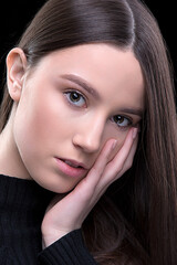 Obraz premium A beautiful young girl with natural beauty with long, smooth hair.