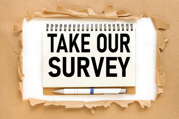 Take Our Survey. text on notepad near torn paper