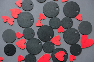 black chalkboard tags with holes and hand painted red hearts on a neutral background