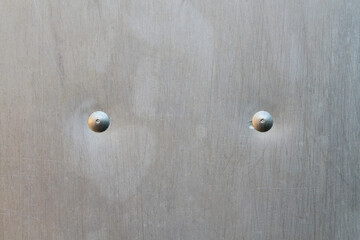 Old metal stainless steel sheet with rivets. Close-up. Background. Texture.