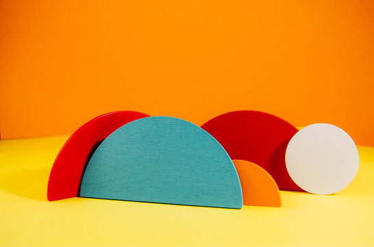 Colorful abstract geometric background with wooden shapes. Front view, copy space