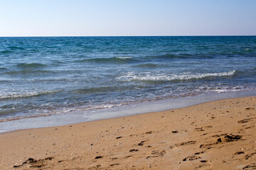 Fototapeta na wymiar Beautiful seascape. Golden sand beach. Summer Idyllic scenery. Calm blue water. Vacation time. 