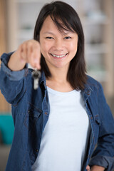 young asian woman holding a set of keys