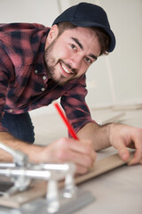 workman writing on a piece of wood