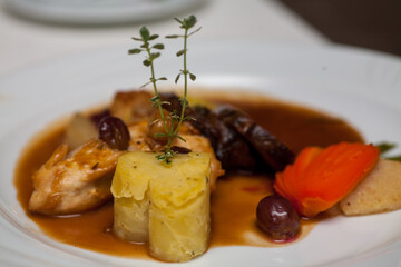 Grilled chicken fillet with heart shaped mashed potatoes, gravy, Mixed vegetables. cauliflower, broccoli and carrots in white plate. High quality photo