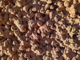 textured and brown cement wall of an old building.
