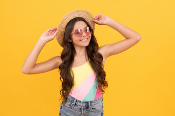 summer portrait. summer party look. happy funny kid in eyeglasses and straw hat.