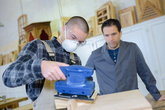 Artisan Cabinet Maker Polishing The Plywood