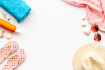 Beach accessories isolated on white. Hat with sunglasses and flip flops. Overhead view