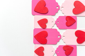 pastel colored wood chalkboard tags with hand painted red hearts, loosely arranged in a retro style - photographed on a white background in a top-down style