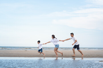 Fototapeta na wymiar a happy family having fun on a beach