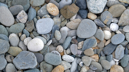 Sea or river multicolored pebbles. Natural texture of beach pebbles. Weathering and erosion of rocks. Drainage systems from small pebbles. Garden drainage for plants and trees. Blue stones for roads.