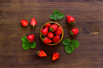 Fresh strawberry with leaf in bowl. Berry background. Top view