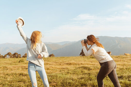 Women having fun in nature and taking photos