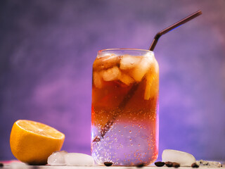 Trendy summer refreshing drink espresso tonic on a colored backlit background