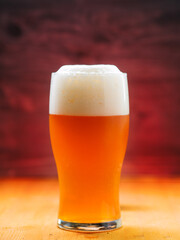 Close-up of a glass of unfiltered craft beer, back light