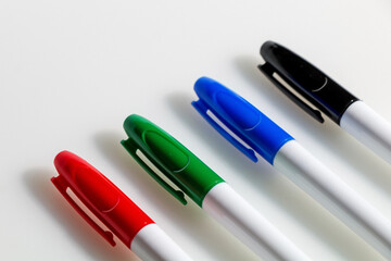 Four multicolored markers on a white background