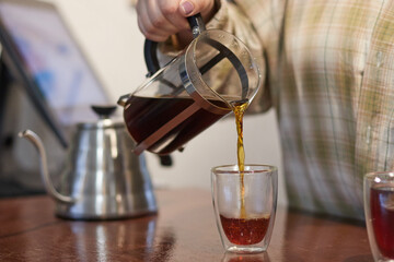 The process of making coffee, a natural coffee drink is filtered through a filter, poured into a cup