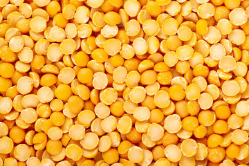 Dry yellow split peas background. Halves of yellow legume peas.