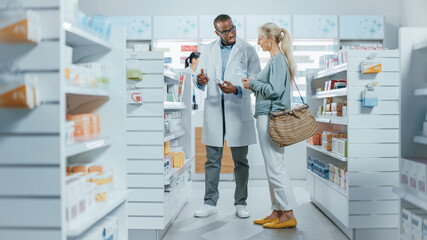 Pharmacy: Professional Black Pharmacist Helping Caucasian Senior Female Customer with Medicine...