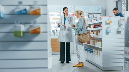 Pharmacy: Professional Pharmacist Helping Beautiful Senior Female Customer with Medicine...