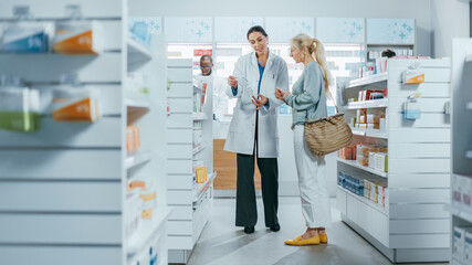 Pharmacy: Professional Pharmacist Helping Beautiful Senior Female Customer with Medicine...