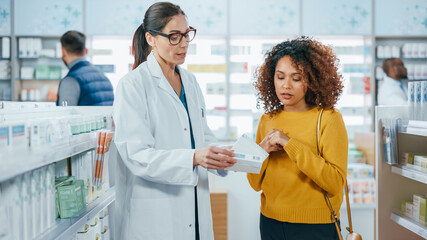 Pharmacy: Professional Caucasian Pharmacist Helping Beautiful Black Female Customer with Medicine...