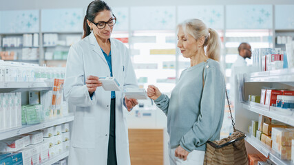 Pharmacy: Professional Pharmacist Helping Beautiful Senior Female Customer with Medicine...