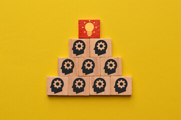 Human head with light bulb icons on wooden blocks
