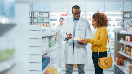 Pharmacy: Professional Black Pharmacist Helping Beautiful Latin Female Customer with Medicine...