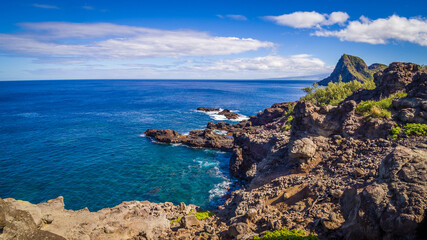 Fototapeta na wymiar Olivine Pools, located along northwestern Maui's rugged coastline, offer large tidepools of clear water perfect for swimming, snorkeling, and sunbathing on a calm day. Maui, Hawaii, USA